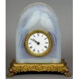An early 20th century Lalique style opalescent pressed glass mantel clock
The domed case with two