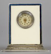 An enamel decorated silver miniature desk clock
With cream and blue enamel decorations,