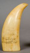 A scrimshaw whale tooth
Typically carved with sailing ship.  14 cm long.