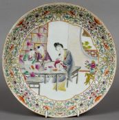 A Chinese porcelain shallow dish
The centre decorated with a calligraphy lesson scene within lotus