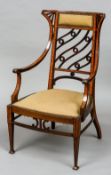 An Edwardian satinwood banded mahogany open salon armchair
With down swept arms and sprung seat,