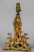A 19th century pierced and scroll cast gilt metal table lamp
Standing on a tripartite base,