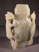 A Chinese carved jade vase and cover
The central vessel flanked with a stylised dragon and phoenix.