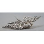 An Edwardian gold and silver diamond set brooch
Formed as a bird, set with an emerald eye.