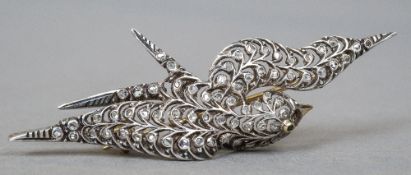 An Edwardian gold and silver diamond set brooch
Formed as a bird, set with an emerald eye.