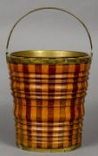 A 19th century Dutch bucket
Of ribbed segmented form with a brass loop handle and liner.