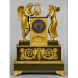 An Empire style gilt bronze figural mantel clock
The 3 inch silvered dial with Roman numerals and