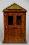 An oak country house letter box
Modelled as a glazed and panelled front door with arched pediment.