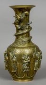 A Chinese bronze baluster vase
Decorated in the round with relief cast figures on a floral engraved