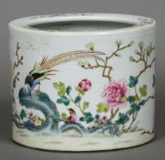 A Chinese porcelain brush pot
Decorated in the round in a famille rose palette with birds amongst