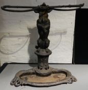 A Victorian cast iron stick stand
Formed as a dog standing on its hind legs holding a riding whip