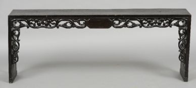 A late 19th century Chinese ebonised bench 
The rectangular top above the scroll and fruit carved