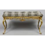 A brass framed upholstered stool
The drop-in seat above the pierced scrolling frieze,