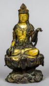 A Chinese gilt decorated bronze figure of Guanyin
Modelled seated, on a naturalistically cast base.