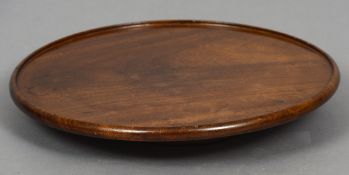 A mahogany Lazy Susan
Of typical dished circular form.  53.5 cm diameter.