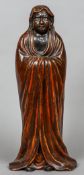 A late 19th century Japanese red lacquered pottery figure
Modelled in a flowing robe.  51 cm high.