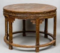 An 18th century and later Chinese elm centre table
The circular top above a carved frieze and