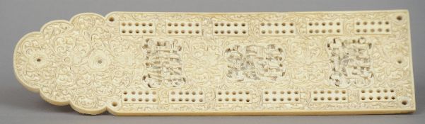 A Chinese Canton carved ivory cribbage board
Profusely worked with figural vignettes amongst