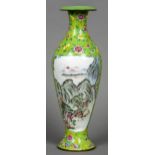 A Chinese Canton enamel vase
Decorated with landscape vignettes within lotus strapwork on a green