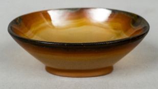 A small carved agate pedestal bowl
Of oval form.  9 cm wide.