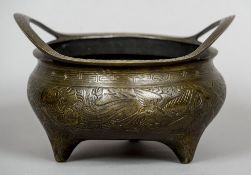 A Chinese bronze twin handled censor
Worked with a dragon, crane and carp,