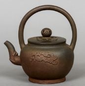 A Chinese Yixing teapot
Of typical brown glaze, with loop handle,