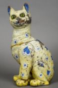 A late 19th century Galle Reinemer faience model of a cat
Typically modelled and decorated in blues