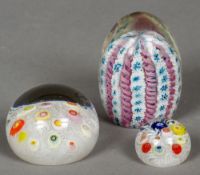 Three glass paperweights
All with interior cane work, one with paper label for Strathearn.