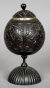 A 19th century carved coconut cup and cover
The main body with carved floral decoration,