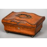 A 19th century satinwood sewing box
The hinged serpentine lid inset with polished steel pique