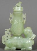 A Chinese carved and pierced jade twin handled vase and cover
Worked atop a recumbent Chinese water