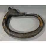 A Chinese carved hardstone Ouroboros
Drilled for suspension.  23.5 cm wide.