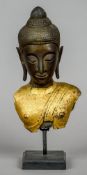An 18th century Thai bronze head and part torso of Buddha
The torso with gold leaf decoration,
