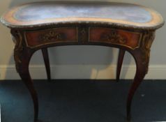 A 19th century French ormolu mounted kingwood kidney shaped ladies writing table
The leather inset