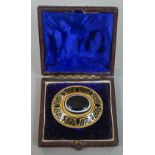 A Victorian unmarked gold, enamel and banded agate brooch
Of domed target form,