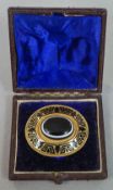 A Victorian unmarked gold, enamel and banded agate brooch
Of domed target form,