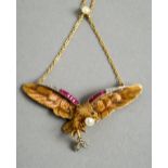 An 18 ct gold diamond, ruby and pearl set pendant
Formed as an eagle,