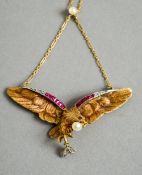 An 18 ct gold diamond, ruby and pearl set pendant
Formed as an eagle,