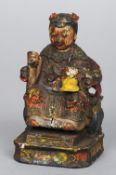 A Chinese carved wood figure of a Royal dignitary
Polychrome decorated.  15 cm high.