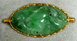 A Chinese predominantly apple green coloured jade brooch
The high carat gold  mount impressed with