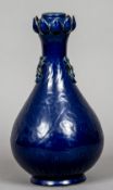 A Chinese porcelain baluster vase
With incised decoration, on a blue ground.  33 cm high.