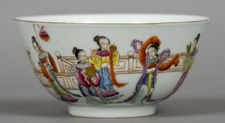 A Chinese porcelain bowl
Decorated in the round with female figures in various pursuits,