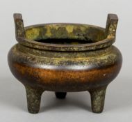 A Chinese bronze twin handled censer
Standing on tripod feet, archaic seal mark to base.  10.