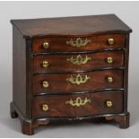 A 19th century mahogany miniature serpentine chest of drawers
With four graduated serpentine