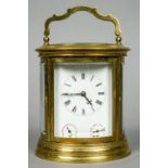 An oval gilt brass cased French striking carriage clock
The white enamel dial with Roman numerals,