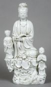 A Chinese blanc de chine porcelain group of Guanyin with child attendants
Typically modelled,