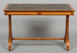 A Victorian satinwood library table
The gilt tooled leather inset rounded rectangular top above