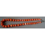 A string of coral beads
Of varying sizes.  52 cm long.