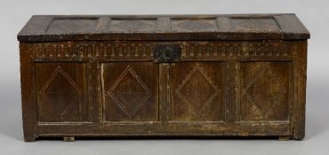 An 8th century carved oak four panel coffer
The hinged panelled top above the four panelled front