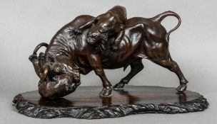 A Japanese Meiji period patinated bronze animalier group
Formed as tigers attacking a bull,